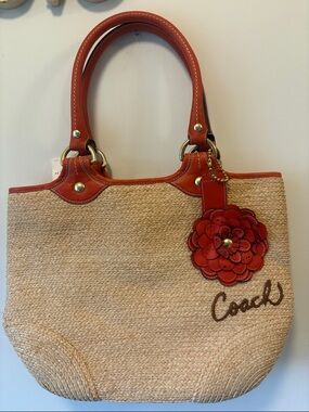 Coach Straw Tote with Red Leather Handles and Flower Charm